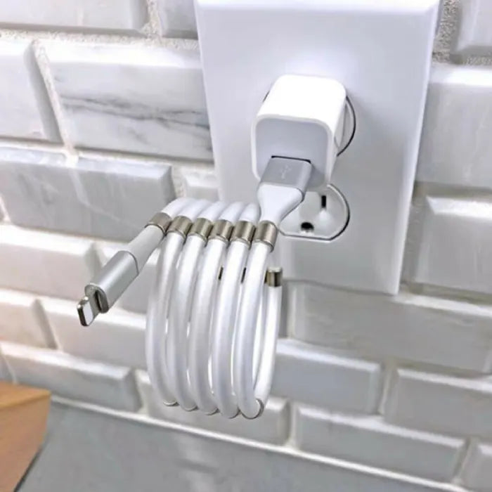 magnetic self coiling usb c charging cable shown forming tight loops beside laptop and phone for stable and tidy charging layout