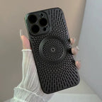 Magnetic wireless phone case in matte black with vented back pattern shown in hand under soft light.