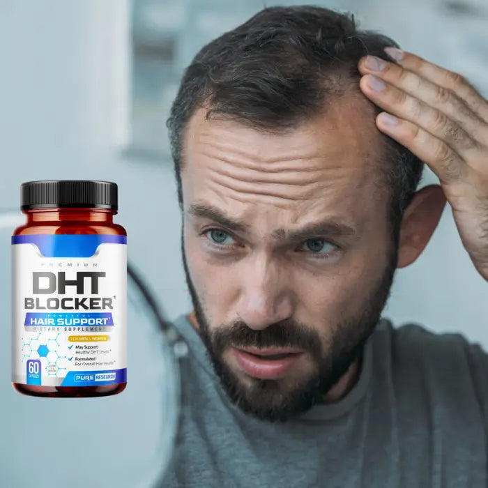 Man examining hair loss in the mirror with a DHT Blocker supplement bottle, emphasizing support for healthier, fuller hair.