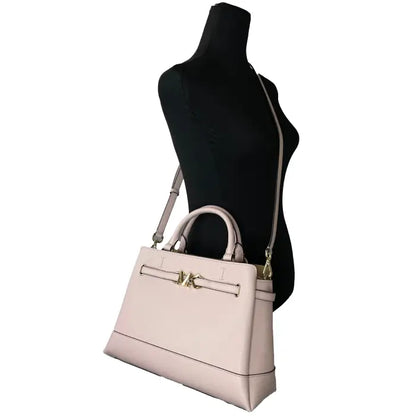 Michael Kors beige handbag on mannequin, highlighting crossbody strap and sophisticated design.