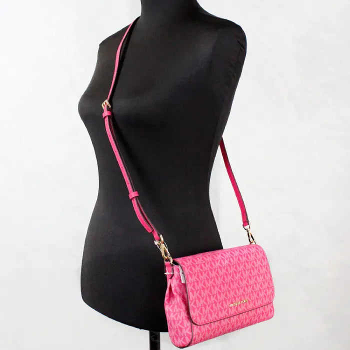 Mannequin wearing Michael Kors pink crossbody, demonstrating adjustable strap fit and stylish look.