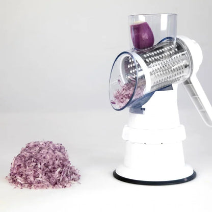 Manual kitchen vegetable cutter in action, grating a purple onion for cooking prep.