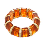 marbled acrylic bracelet in rich amber color with gold accents displayed on white background