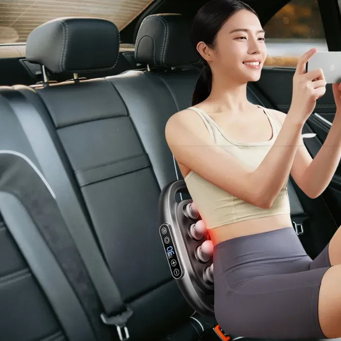 Massage Gun back massager used in a car seat, delivering powerful 16-head deep pressure for travel-friendly back pain relief