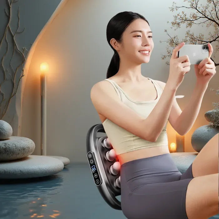 Massage Gun back device used by a woman relaxing indoors, showing heated deep tissue action for soothing muscle relaxation