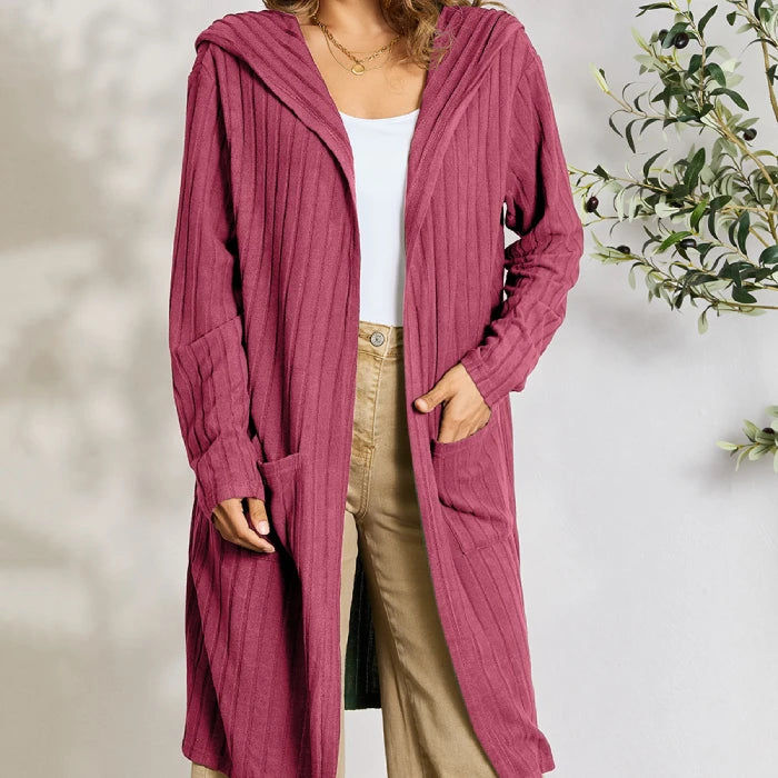 Casual mauve pink long cardigan with ribbed texture styled with beige wide-leg pants and white top for modern fashion