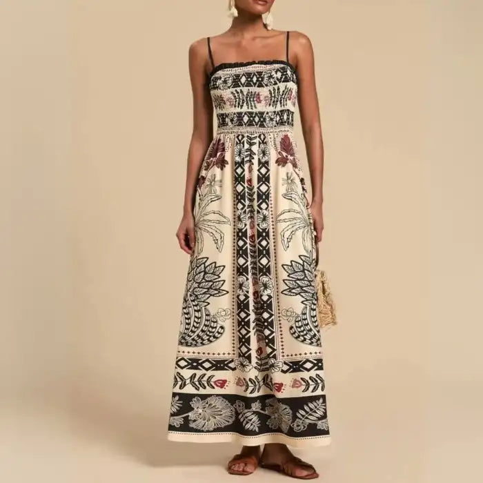 Maxi dress with black and beige boho prints, square neckline and thin straps styled with tassel bag.