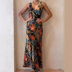 Maxi dress in satin with vivid floral print, fitted silhouette, and plunging neckline for evening wear.