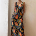 Maxi dress in vivid multicolor with deep V-neck, sleeveless cut, and flowing summer-ready silhouette.