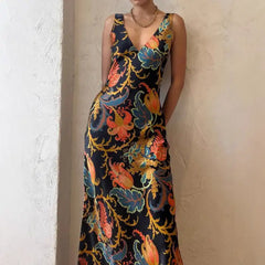 Maxi dress in vivid multicolor with deep V-neck, sleeveless cut, and flowing summer-ready silhouette.