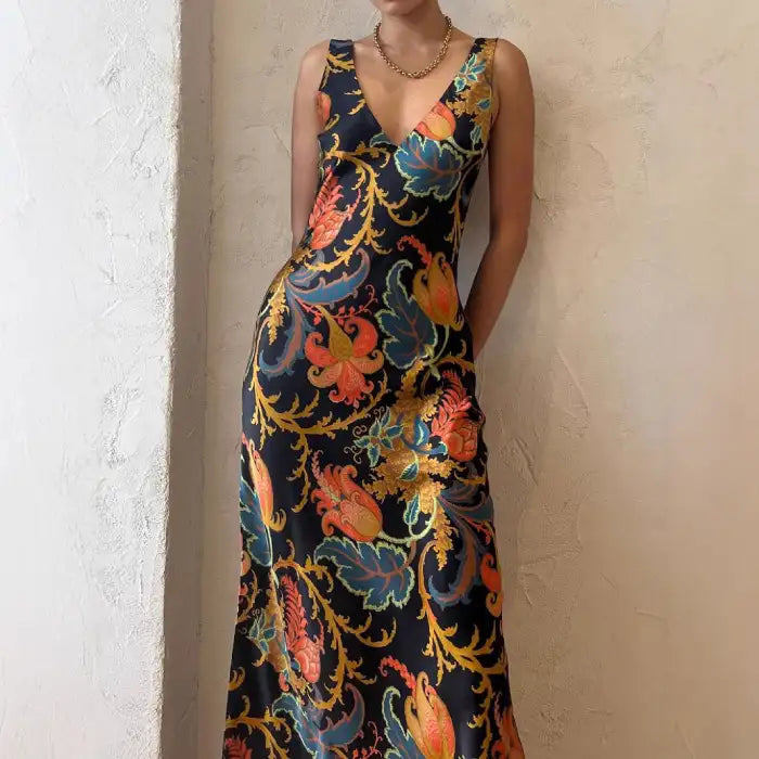 Maxi dress in vivid multicolor with deep V-neck, sleeveless cut, and flowing summer-ready silhouette.