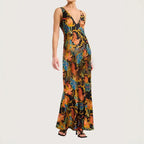 Maxi dress with tropical floral print in vibrant tones, form-fitting cut, and flared hem for resort style.