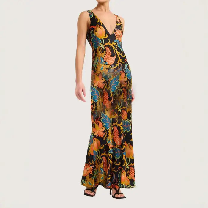 Maxi dress with tropical floral print in vibrant tones, form-fitting cut, and flared hem for resort style.