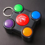 Close-up of memory game toy with red center and four colorful buttons with attached keychain.