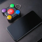 Memory game toy with keychain placed next to smartphone to show compact size.