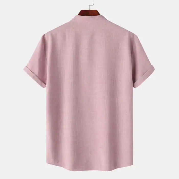 Men's blouse maroon plain fabric with short sleeves and rolled cuffs back view on hanger