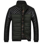 Mens insulated jacket in green and black with quilted shoulders and padded body.