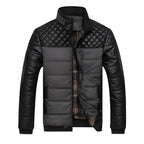 Mens insulated jacket in grey and black featuring quilted panels and a warm plaid lining.