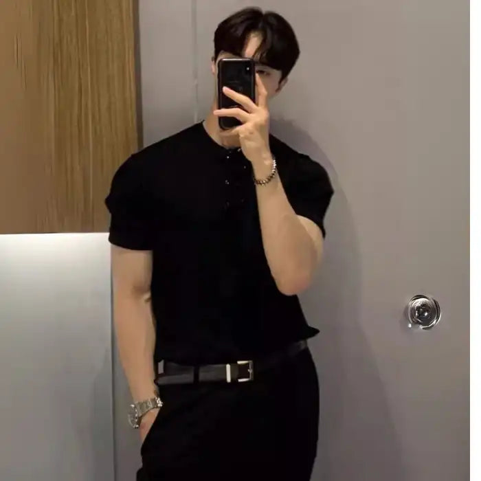 Men's plus size ribbed knit t-shirt in black styled with black trousers and silver watch.