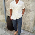  Men's plus size tied lightweight linen wrap top white paired with navy pants shown from side outdoors