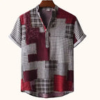 Men's plus size printed short sleeve blouse with patchwork pattern in red, black, and gray colors on hanger.