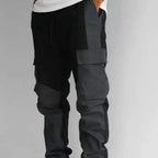 Men's trousers in black and gray with cargo pockets and a relaxed fit shown on a model
