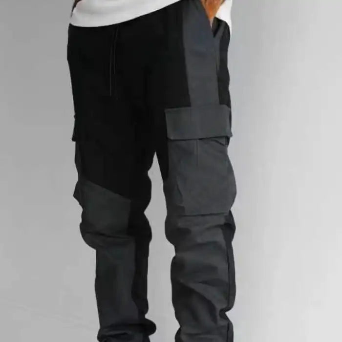  Men's trousers in black and gray with cargo pockets and a relaxed fit shown on a model