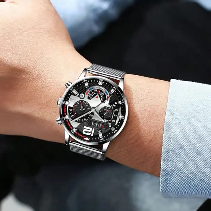 Men's watches silver chronograph with mesh band worn on wrist with formal blue shirt