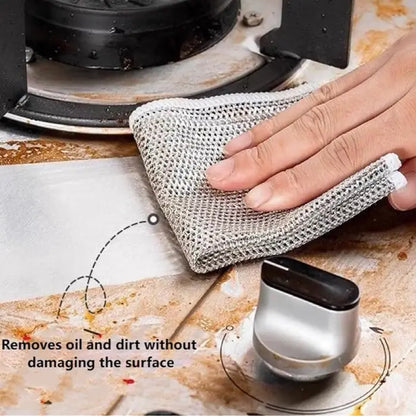 mesh dish cloth removing grease and dirt from a stovetop, demonstrating its non-scratch and oil-removing capabilities.