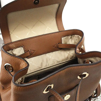 Interior of Michael Kors brown leather backpack with branded lining and spacious compartment.