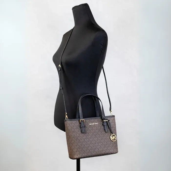 Michael Kors brown monogram tote shown on black mannequin for size perspective