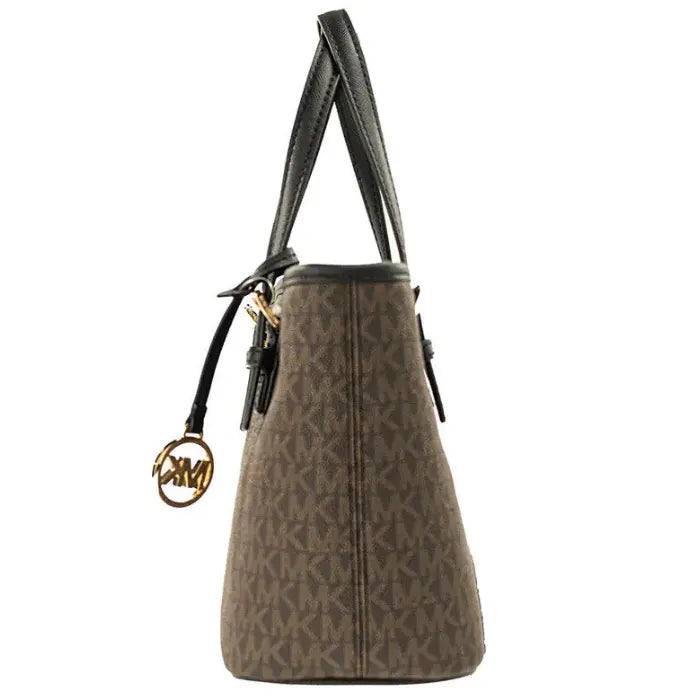 Side profile of MK brown monogram tote featuring gold MK charm and black leather handles