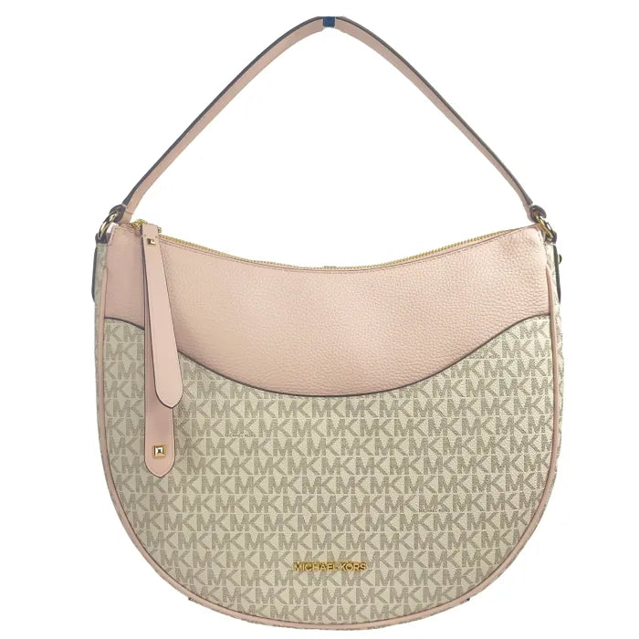 Detail view of Michael Kors hobo showing pink leather panel and gold hardware against vanilla monogram canvas