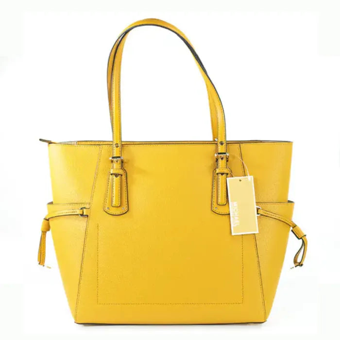 A bright yellow Michael Kors Voyager tote bag with double handles, side drawstrings, and gold-tone hardware.