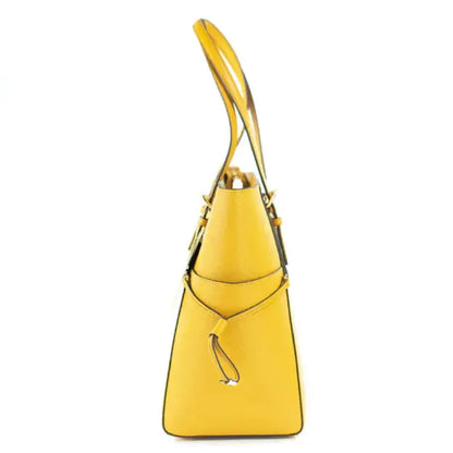 Side profile of yellow Michael Kors Voyager tote showcasing trapezoid silhouette and side drawstring detail.