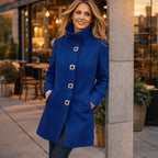 Mid length wool coat in vibrant blue styled casually at a city café, delivering warmth with a confident modern look.