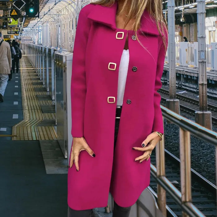 Mid length wool coat in bold pink designed with a sleek cut and decorative buttons to elevate cold weather outfits.