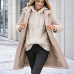 Mid length wool coat in soft beige layered over a knit sweater, designed for casual comfort and cold weather style.