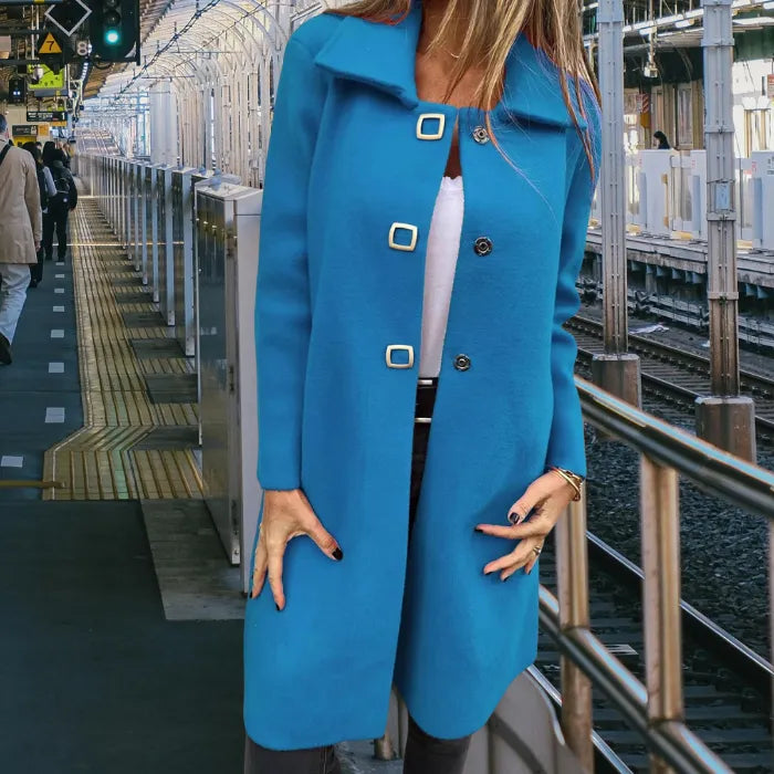 Mid length wool coat in modern teal with clean lines and soft texture, offering stylish warmth for city commuting days.