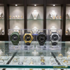 military tactical analog digital sport watch collection showcased in display case with multiple color options for shopper comparison