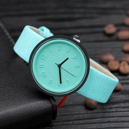 Mint green wristwatch with embossed numbers and black hands for fresh, fashionable accessories.