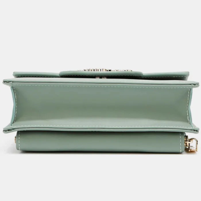 Bottom view of structured mint green handbag showing stitching details and gold hardware