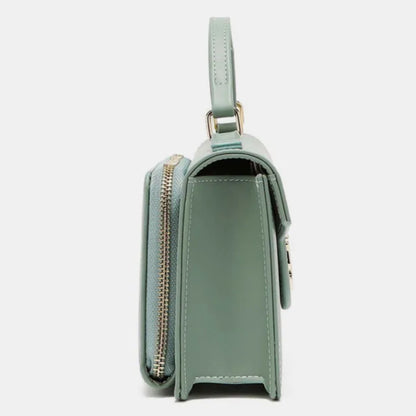 Side profile of mint green structured handbag showing shape and gold hardware details