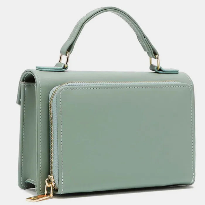 Side view of mint green handbag showing gold zipper detail and structured shape