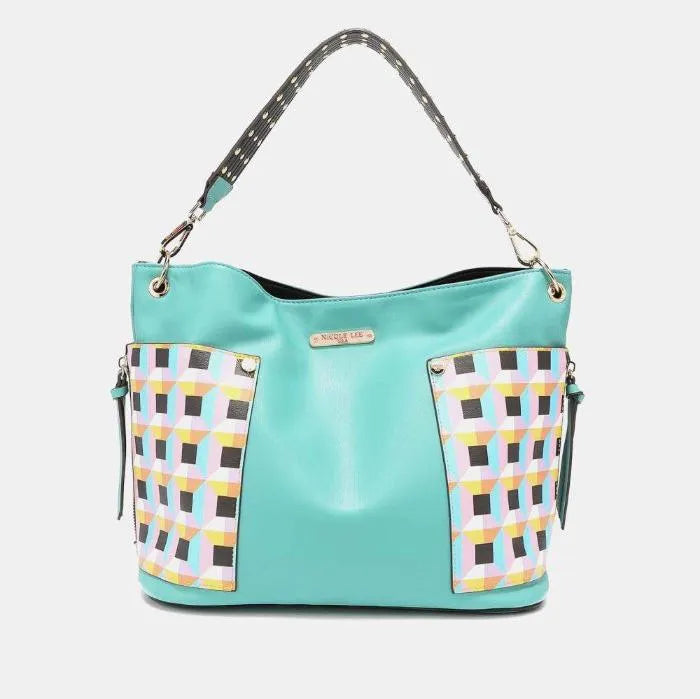 Contemporary mint leather handbag with geometric print side panels and adjustable spotted shoulder strap