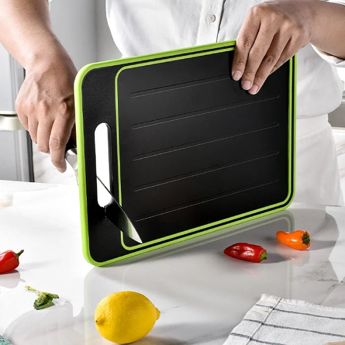 Clean green and black cutting board held by chef in a white kitchen setup.