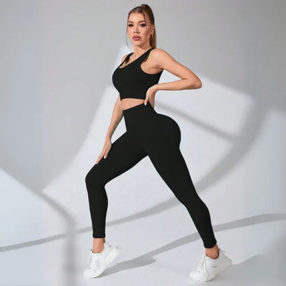 Contemporary fitness set in black with ribbed texture, featuring crop top and form-fitting leggings with white sneakers