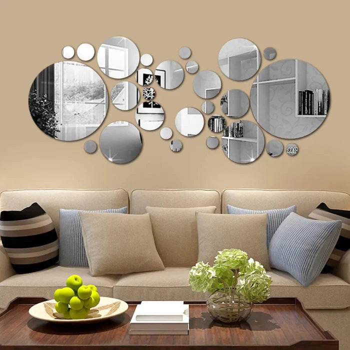 Circular mirror wall art above white sofa in modern living room, with decorative fruits and books