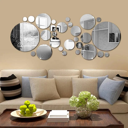 Circular mirror wall art above white sofa in modern living room, with decorative fruits and books