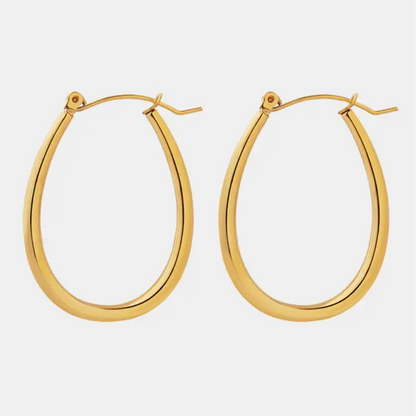 Polished gold teardrop-shaped hoop earrings on white background